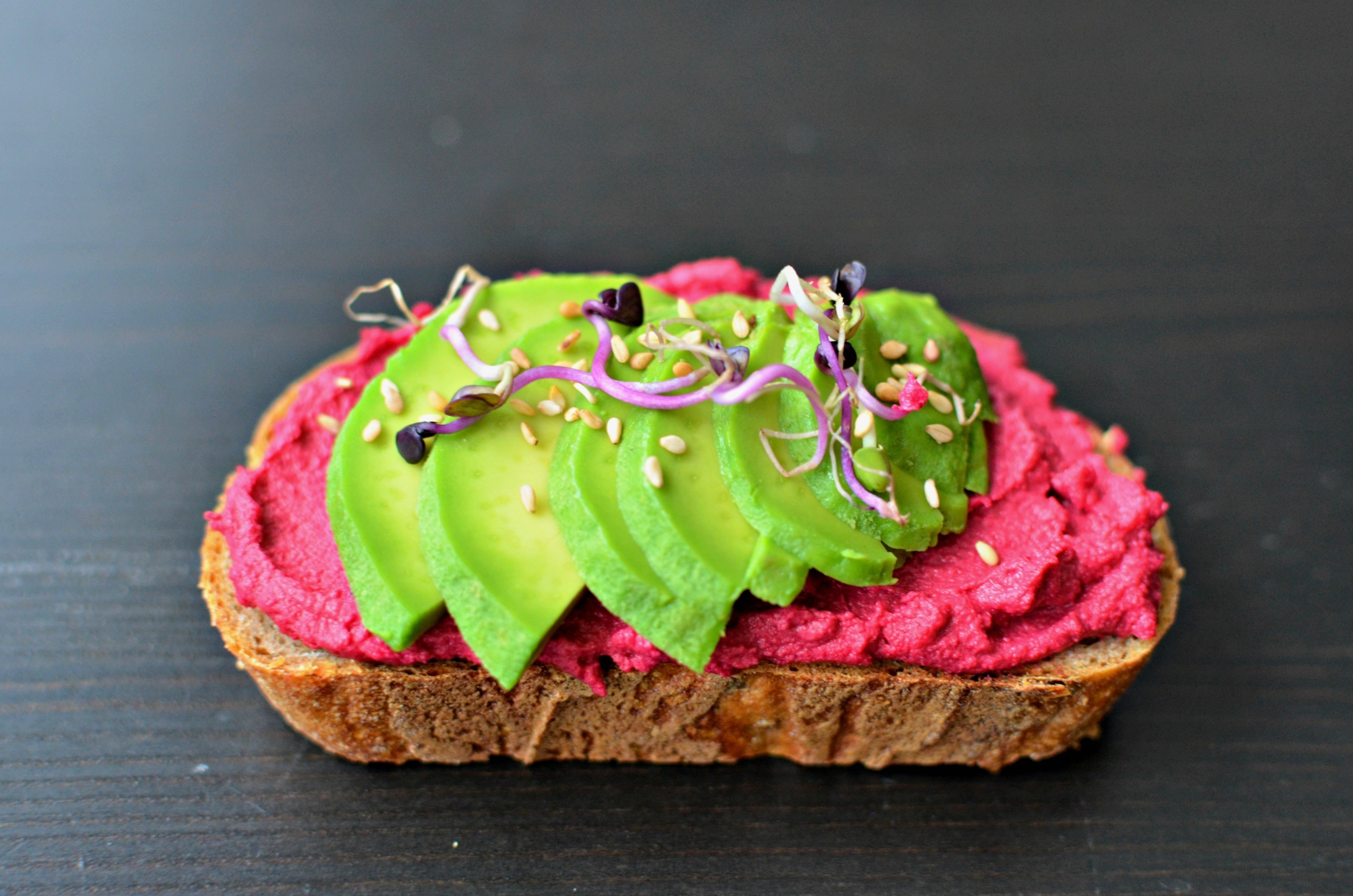 AVOCADO TOAST WITH BEETROOT HUMMUS AND SPROUTS